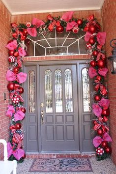 the front door is decorated with red and pink ornaments