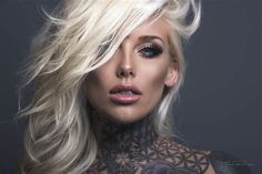 a woman with blonde hair and tattoos on her chest