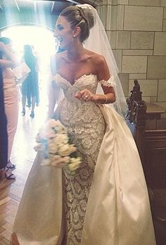 a woman in a wedding dress is walking down the aisle