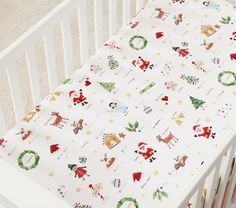 a white crib with christmas wrapping on it