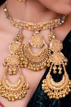 Gold toned necklace with thread, mirror, dabka and tikki hand embroidery. Comes with pair of earrings, maangtikka, paasa, pair of haathphool and a nose ring.
Components: 1 Necklace, Pair Of Earrings, 1 Maangtikka, 1 Paasa, Pair of Haathphool, 1 Nose Ring
Type: Thread, mirror, dabka, tikki
Composition: Metal
Color: Gold
Other Details: 
Dimensions L x W (in inches):
Necklace: 15 x 11.5
Earrings: 10.5 x 5.5
Maangtikka: 14 x 4.75
Paasa: 13 x 6
Haathphool: 12.5 x 9.25
Nose Ring: 5.5 x 5.5 - Aza Fashi Semi-stitched Gold Anarkali Set With Motifs, Eid Festival Gold Sets With Motifs, Bollywood Style Chandbalis With Gota Work For Designer Wear, Temple Jewelry Kundan Chandbalis With Motifs, Traditional Chandbali Jhumkas For Designer Wear, Bollywood Style Chandbali Earrings For Designer Wear, Kundan Jewelry With Motifs For Navratri, Kundan Chandbali Tikka With Motifs, Chandbali Jhumkas For Designer Wear