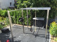 an outdoor gym with bars, squats and pull ups in the middle of a garden