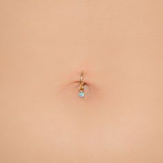 the back of a woman's stomach with a small ring on top of it