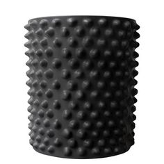 a black vase with holes on it