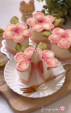 small desserts with pink flowers and leaves on a white plate