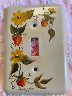 a light switch cover with flowers painted on it