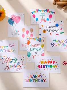 happy birthday cards with balloons and confetti are arranged on a white table top