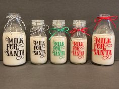 six glass bottles filled with milk sitting on top of a table