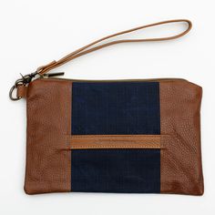 Stylish and durable, this Eastport Clutch is made to accompany you on all of your travels. Perfect for those on the go! Attach the Eastport Clutch to the inside of the Saco River tote Bag or the Fore Street Tote Bag (sold separately) to make a stylish set. Due to the nature of the leather, variations in color may occur. Made in a solar-powered workshop in Maine. Includes detachable leather wrist strap with a bronze lobster clasp built-in leather hand clutch strap zip-top closure Materials waxed Rectangular Travel Accessories With Removable Pouch For On-the-go, Brown Travel Accessories With Leather Handles, Brown Travel Accessories With Luggage Sleeve For Everyday Use, Everyday Brown Travel Accessories With Leather Handles, Brown Travel Accessories With Leather Handles For Everyday, Handheld Brown Pouch For Daily Use, Handheld Zipper Pouch Bag For Travel, Handheld Travel Bag With Zipper Pouch, Functional On-the-go Pouch With Luggage Sleeve