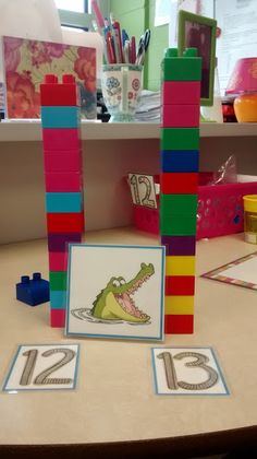 a table topped with lots of toys and building blocks on top of eachother