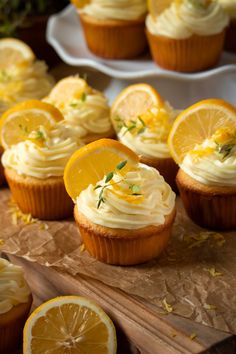 cupcakes with orange slices and lemon zest on the top are ready to be eaten