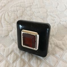 "Vintage Modern Art Deco Style Ring. Square Ring With Amber Middle Gem With Silver Frame and Black Square Setting. Costume Square Ring. This ring has some wear on it but it is in good shape for its age. Size: 7 1/2, Black Square: 1 3/16\" Wide For other vintage jewelry and other items see: www.VeryVictorianStudio.etsy.com For sewing related items see my other shop: www.SewingRoomStore.etsy.com Thank you for looking!" Unique Black Collectible Rings, Unique Black Rings For Collectors, Modern Black Enamel Ring For Gift, Vintage Black Enamel Ring For Formal Occasions, Black Vintage Enamel Ring, Unique Black Rectangular Jewelry, Vintage Black Rings For Jewelry Making, Handmade Black Metal Rings, Orange Ring