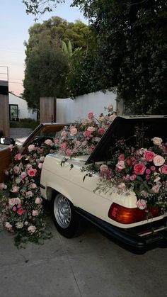 a car with flowers growing out of it's trunk