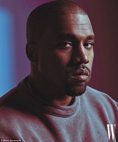 a close up of a person wearing a sweatshirt and looking off to the side with a serious look on his face