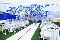 an outdoor event setup with white and blue decor