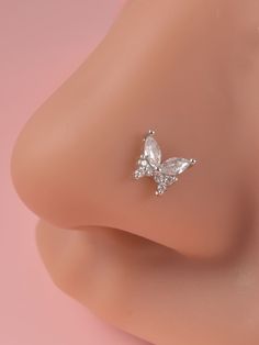 the side view of a woman's nose with a diamond butterfly on it