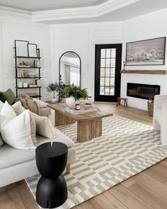 a living room filled with furniture and a fire place in the middle of the room