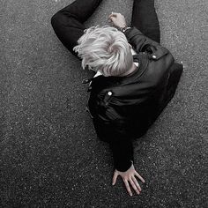 a woman laying on the ground with her legs spread out and hands in the air