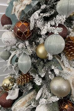 a christmas tree decorated with silver and gold ornaments