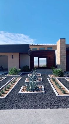 a house with many plants in front of it