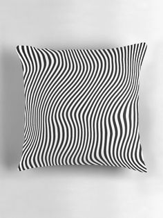 a black and white pillow sitting on top of a wall