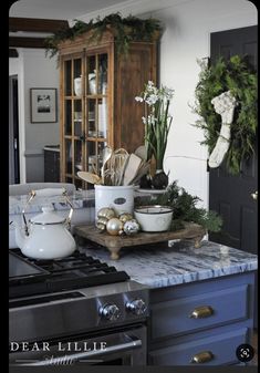 the kitchen counter is covered with christmas decorations and dishes, including pots and pans