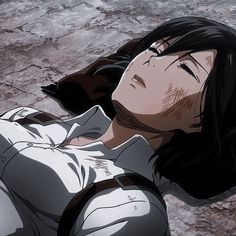 a woman laying on the ground with her eyes closed