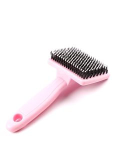 a pink brush with black bristles on it