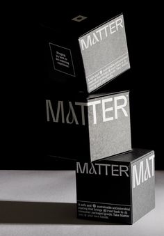 three boxes stacked on top of each other in front of a black background with white lettering