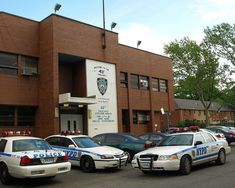 several police cars parked in front of a building