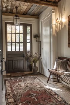 a room with a door and rug on the floor in front of it, next to a couch