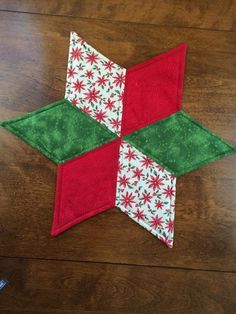 a red and green patchwork star on a wooden table