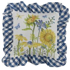 a blue and white gingham pillow with sunflowers on it