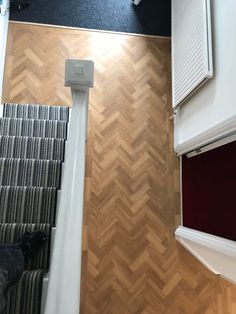 an overhead view of a room with wood flooring and white trim on the walls