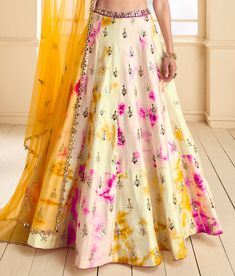 COLOR : Cream Yellow & Magenta FABRIC : Top (Blouse) - Premium Silk, Bottom (Lehenga) - Premium Silk, Inner - Cancan, Dupatta - Net WORK : Foil, Gota Work, Sequins, Digital Print, Motifs, Lace Border OCCASION : Wedding, Reception, Sangeet, Engagement READY-TO-WEAR : NoSTITCHING : Available as semi-stitched fabric, can be stitched using standard size option (+$30). Note: There might be a slight color variation due to lighting and flash used during photoshoot. The bright shade seen is the best clo Multicolor Embroidered Raw Silk Dress For Wedding, Raw Silk Dress With Multicolor Embroidery For Wedding, Multicolor Fitted Traditional Wear For Wedding, Multicolor Raw Silk Choli For Wedding, Multicolor Raw Silk Sharara For Wedding, Floral Embroidered Gown For Wedding And Festivals, Multicolor Floor-length Salwar Kameez For Wedding, Multicolor Embroidered Raw Silk Wedding Set, Multicolor Raw Silk Salwar Kameez For Wedding