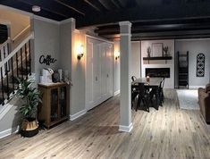 a living room filled with furniture and a fire place next to a stair case in front of a fireplace