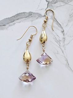 Beautiful natural Ametrine dangling from gold filled beads.  Ametrine is a combination of amethyst and citrine within one stone.  All the known ametrine had been mined so the only stones available are those already on the market - a difficult and expensive stone to find.    For me, creating jewelry is creating art I never create the same piece twice.   Ametrine combines and amplifies the benefits of chakras - the citrine (solar plexus) and crown (amethyst); citrine increases focus aided by the inspiration of amethyst. Don't lose your earrings!  Ear nuts are included with purchase. Handmade Amethyst Crystal Earrings In Gold, Gold Amethyst Long Drop Earrings, Gold Amethyst Gemstone Crystal Earrings, Gold Amethyst Crystal Earrings With Gemstone, Gold Amethyst Crystal Earrings, Gold Amethyst Earrings With Gemstone Accents, Gold Amethyst Drop Earrings, Ametrine Earrings, Expensive Stones