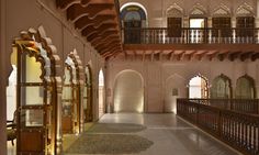 the inside of an ornate building with arched windows and wooden balconies on either side