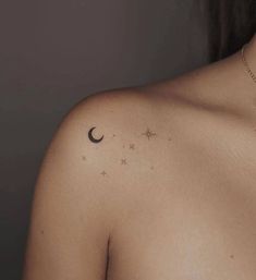 a woman's chest with stars and a crescent tattoo on her left side shoulder