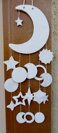 a door decorated with white stars and crescents hanging from it's side,