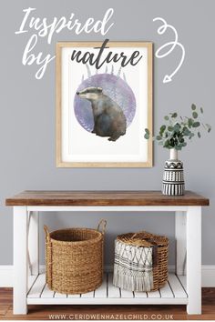 an art print is hanging on the wall above a table with baskets and plants in it