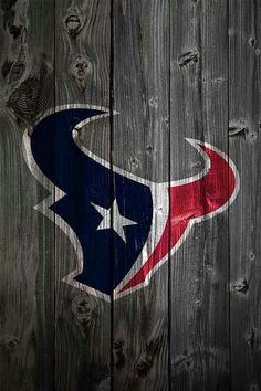 the houston texans logo is painted on a wooden fence