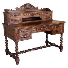 an old wooden desk with ornate carvings on the top and bottom drawers, sitting against a white background