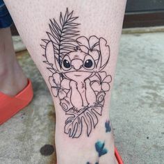 a small tattoo on the leg of a woman's foot with an image of a koala