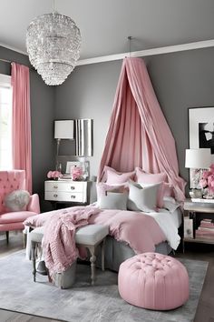 a bedroom decorated in pink and grey with a canopy bed, chandelier, chair, ottoman, rugs and pictures on the wall