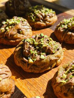 chocolate chip cookies with sprinkles and pistachio on a cutting board