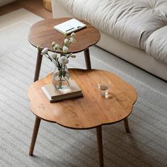 a coffee table with flowers in a vase on top