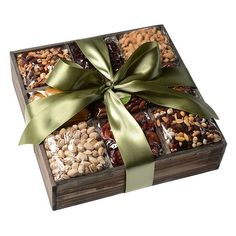 a wooden box filled with assorted nuts and dried fruits, tied with a green ribbon