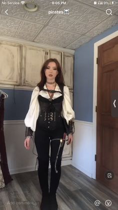 a woman in black and white corset walking through a room