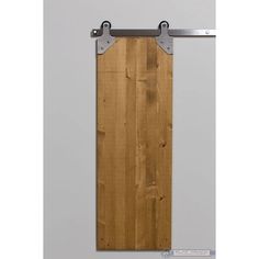 a wooden door with two metal brackets on it